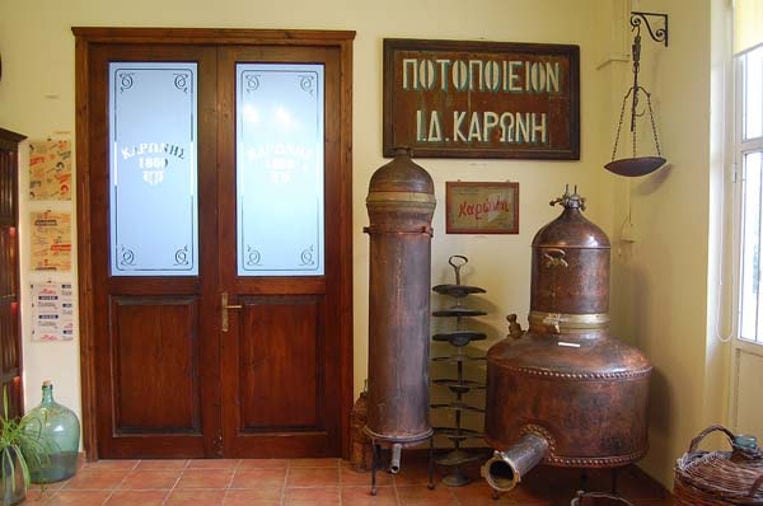 inside Karonis museum entrance with old pieces copper distillery on the one side