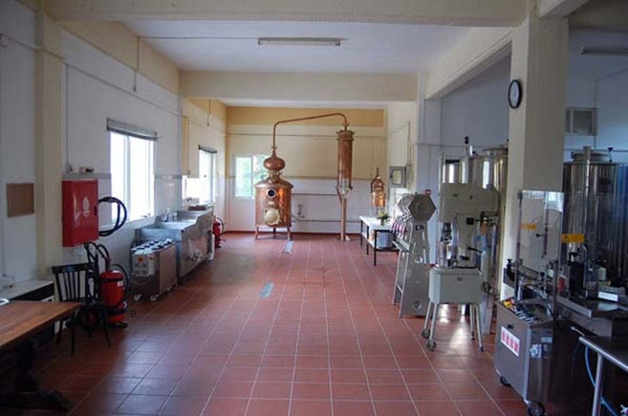 corridor of Karonis Distillery plant with packaging machine on the one side