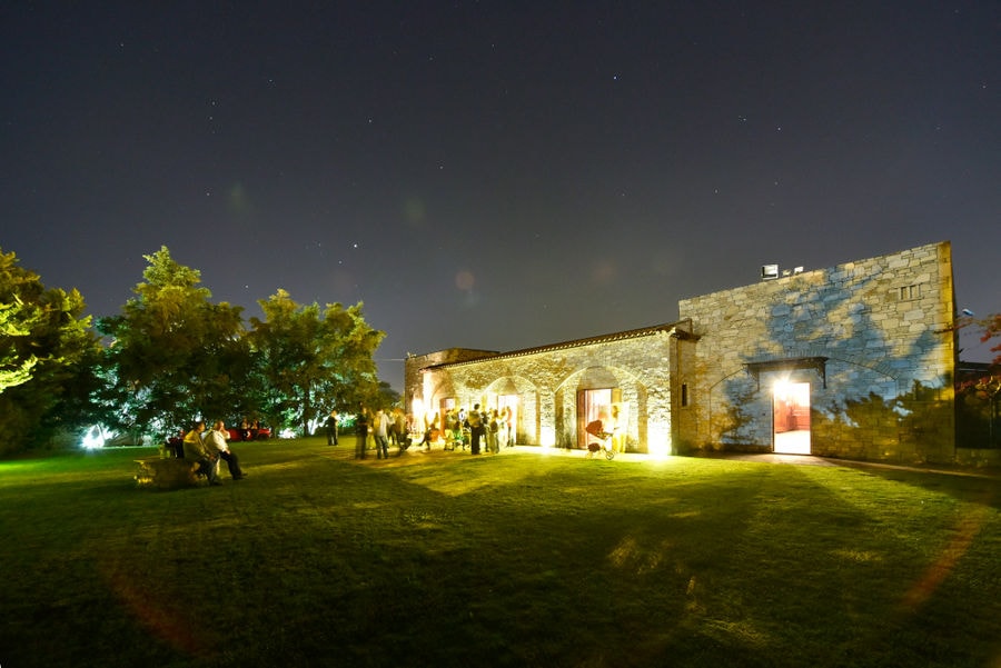 green lawn front the Kellari Papachristou winery by night