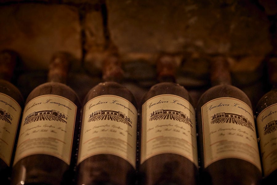 wine bottles storaged in the stone wall in Kellari Papachristou cellar