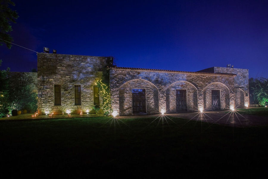 green lawn front the Kellari Papachristou winery stone building by night