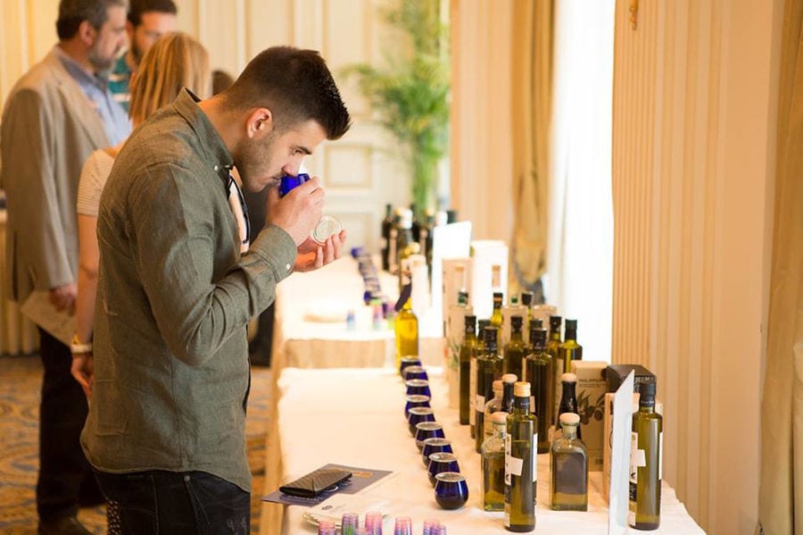 visitors tasting and smell olive oil at Konstas Olive Tours room
