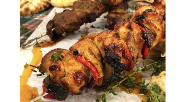 close-up of Greek ‘Kontosouvli’ food made from pieces of meat marinated with chopped onions