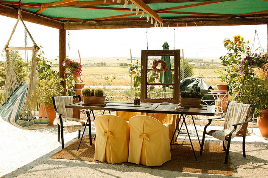 wood watchtower with table and chairs and a hammock at Efkarpia Farm