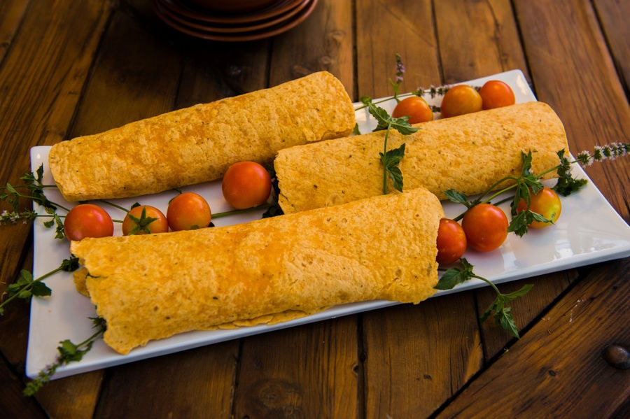 pitas bread with small tomatoes on the plateau at Efkarpia Farm