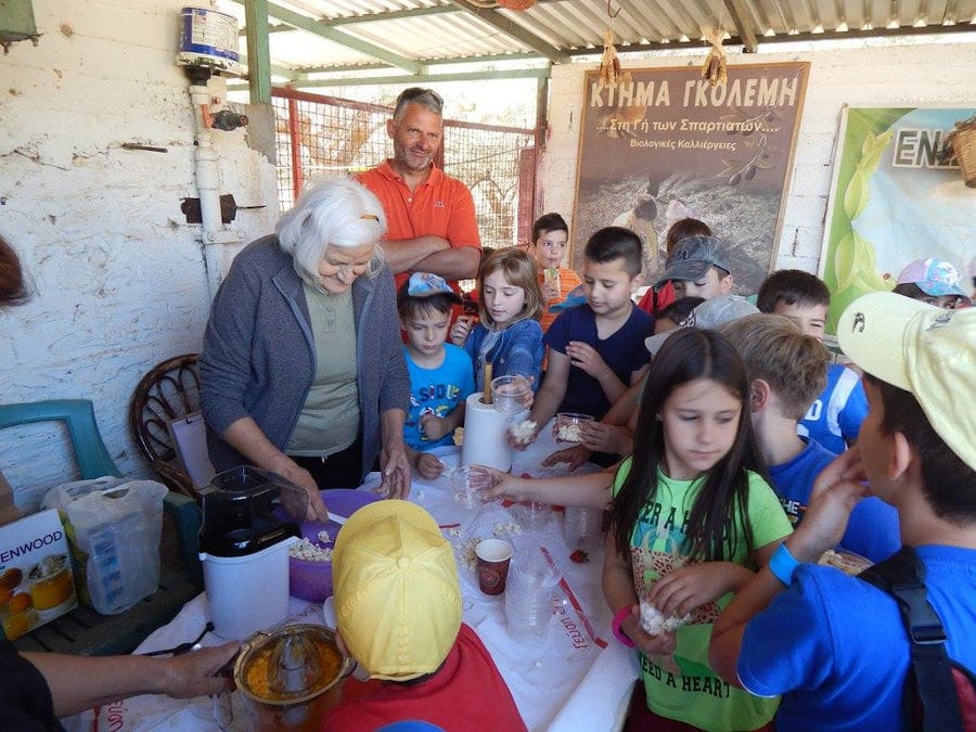 a old woman served with sandwiches a group of pupils at 'Ktima Golemi' farm