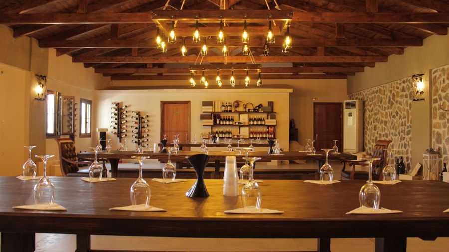 wood tables with benches Ktima Karamitsos illuminated tasting room