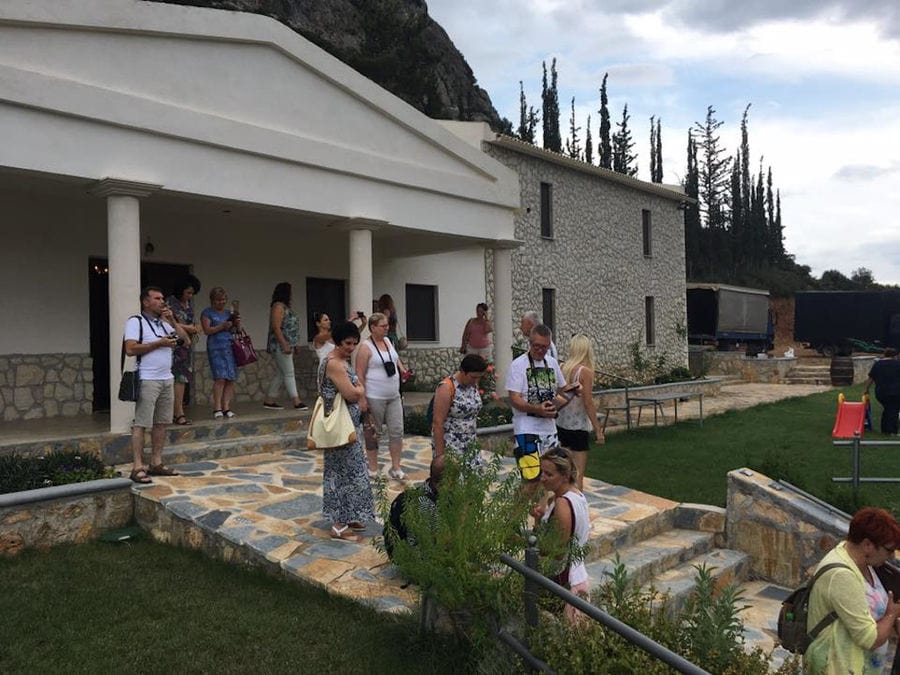 outside Ktima Karamitsos entrance with columns and tourists and green lawn on the both sides