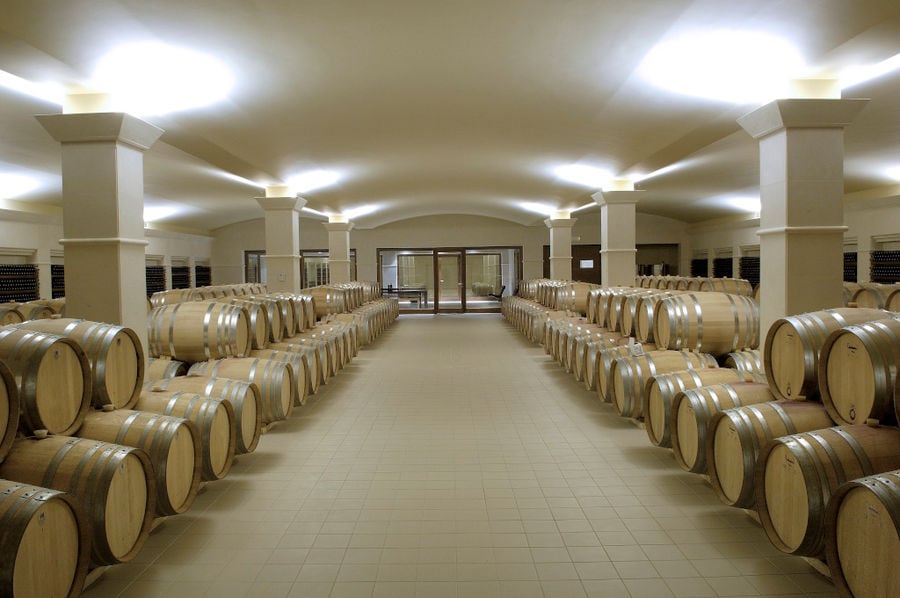 wine wood barrels on top of each other at 'Ktima Pavlidis' cellar