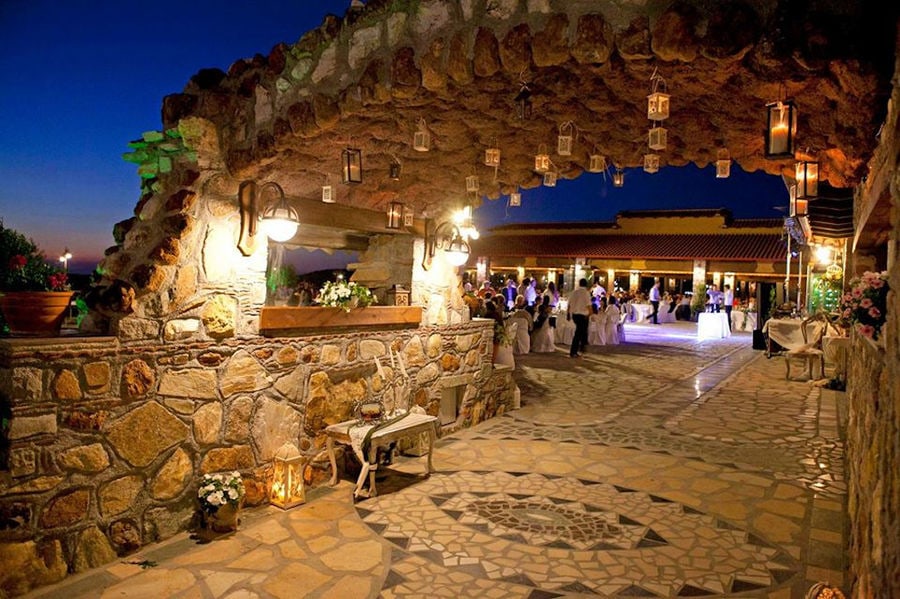Party at illuminated stone building of Ktima Perek by night outside at the restaurant