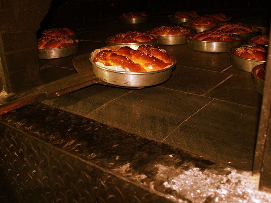 cooked tsoureki Greek Easter cakes in round bakery pans in the oven at Ktima Perek