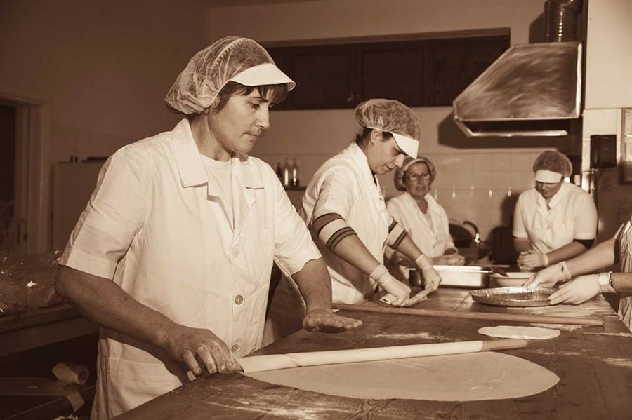 women using wood dough paddles to make pies at Ktima Perek workshop