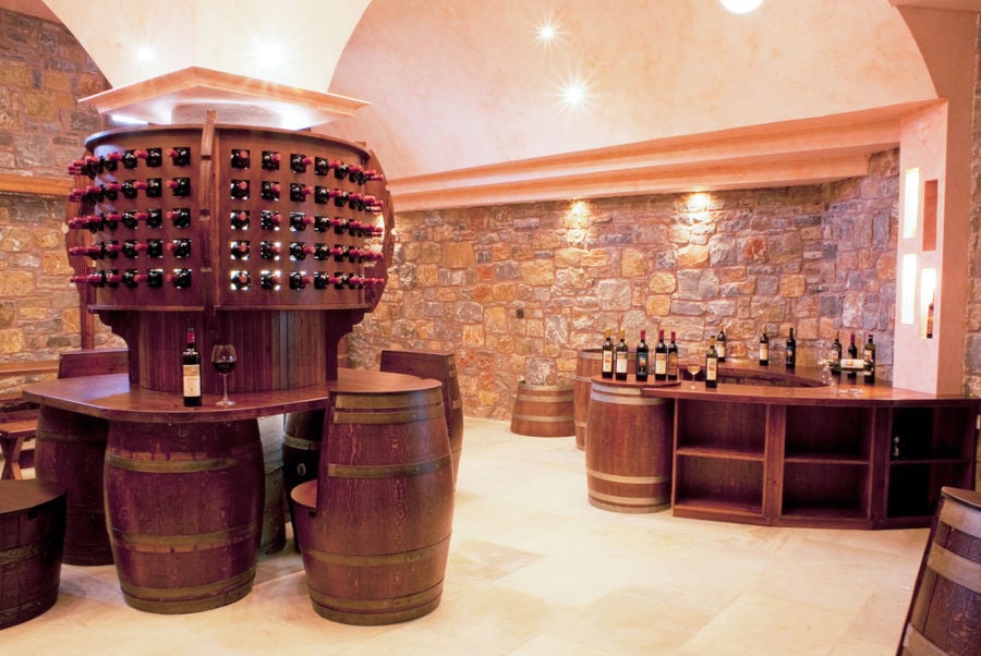 illuminates 'Ktima Toplou' tasting room with tables from wood barrels and stone walls