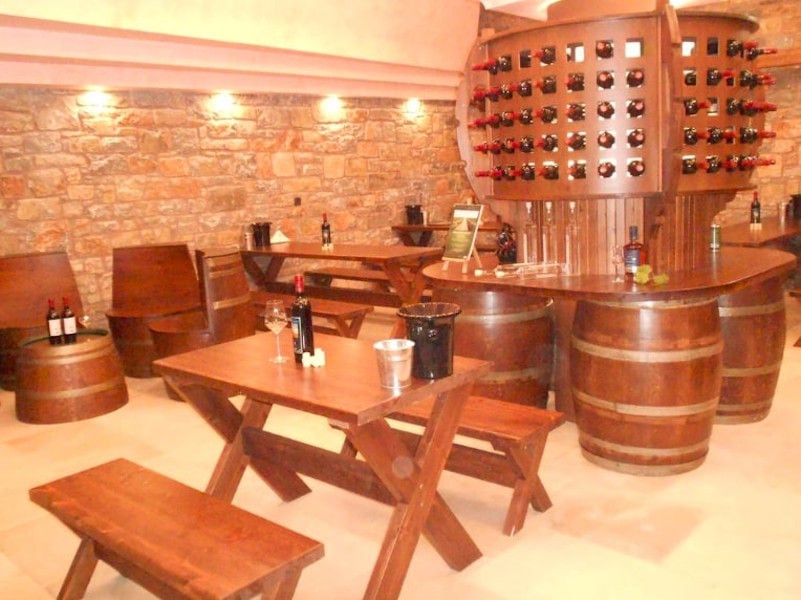 wood table with benches at 'Ktima Toplou' tasting room