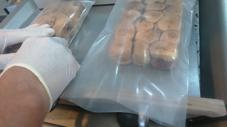 woman packaging dry figs at 'Ktimata Moschouta' workshop