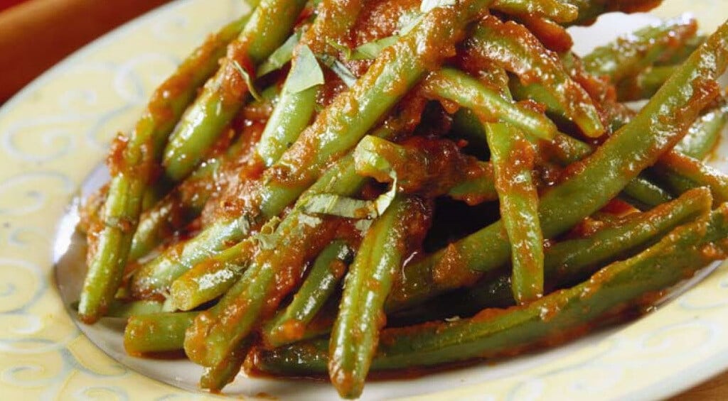 Close-up of plate with Greek ‘ladera’ means cooked beans with pods with tomatoes sauce