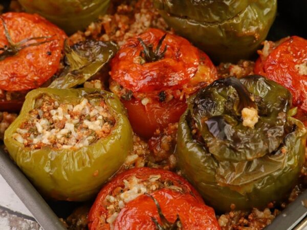 Close-up of plate with Greek ‘ladera’ means tomatoes and peppers stuffed with rice cooked in oven|