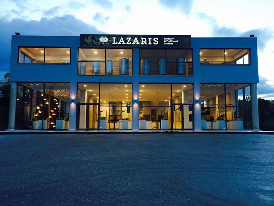 blue building by night that says 'LAZARIS' in upper part of the entrance