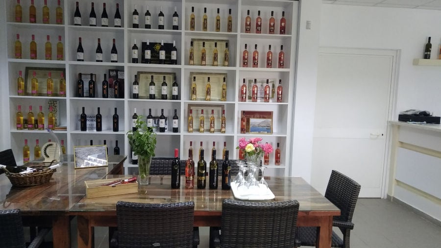'Limnos Organic Wines' tasting room with wine bottles in the storage lockers and a wood table