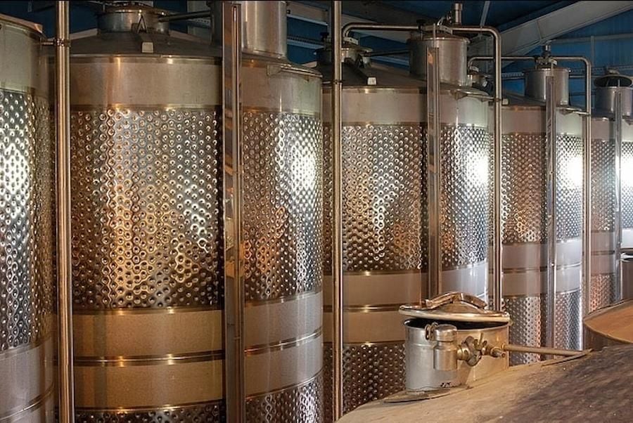 lying aluminum wine storage tanks in a row at Domaine Dereskos winery facilities