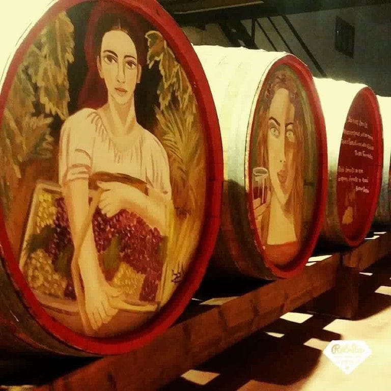 Painted wood barrels representing a face of girl at 'Lykos Winery' cellar