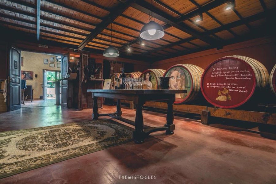 Painted wood barrels at illuminated 'Lykos Winery' cellar