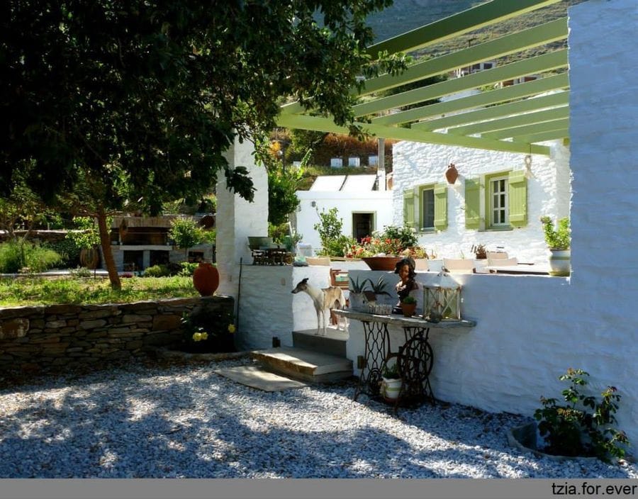 front view of 'La Maison Vert Amande' building with terrace covered with wood pergola