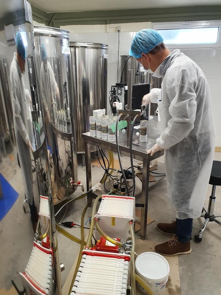 man bottles olive oil at Mer des Oliviers de Delphes premises