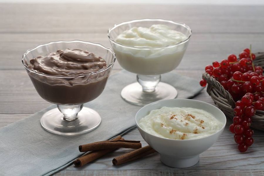 bowls with vanilla and chocolate creams and rice pudding with cinnamon from Mandrekas Greek Yogurt