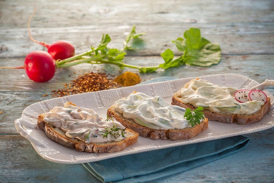 plate with Mandrekas Greek Yogurt fresh cream cheese and fresh parsley on the top on bread