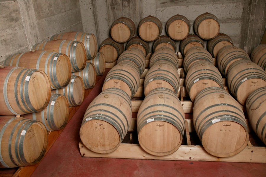 wine wood barrels on top of each other at 'Manolesakis Estate' cellar