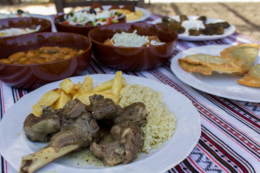 plate with cooked lamb with fried potatoes and rice on the table at Manousakis Winery restaurant