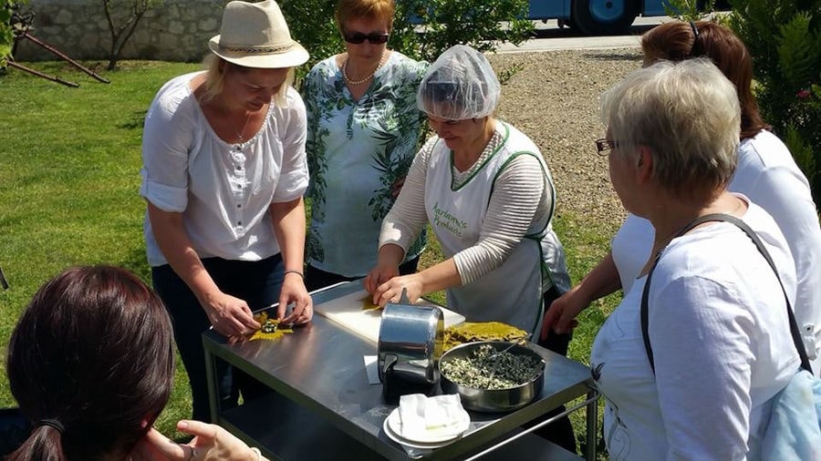 group of women cooking Greek dolmades at 'Marianna' outside