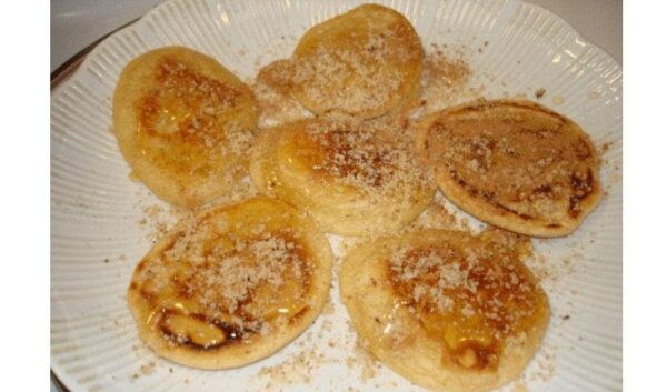 Close-up of round Greek ‘Marmarites’ sweet means pancakes baked on stone and served with honey and almonds