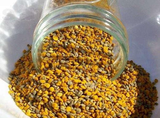 close-up of bee pollen falling out from a glass jar at 'Melissokomiki Dodekanisou Bee Museum'