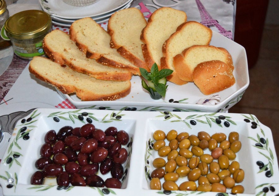 close-up of plateaus with slices of bread and green and black olives at Melas Epidauros