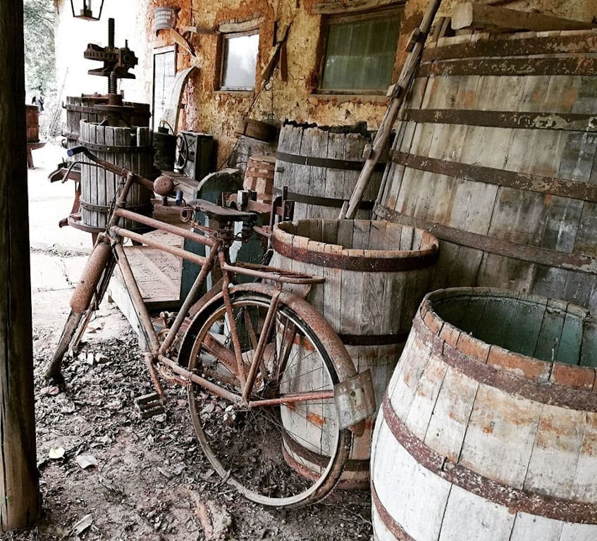 old bicycle, wood barrels and manual grape press at 'Mercouri Estate' facilities