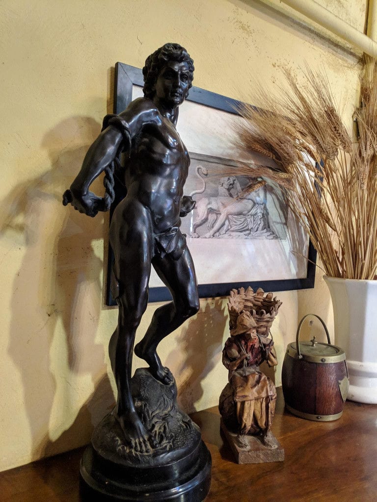 bronze statue like bronzed Apollo and a painting at 'Mercouri Estate' winery