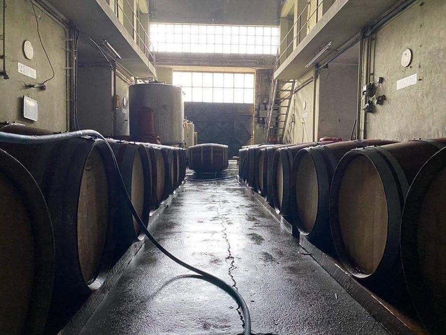 corridor at Minos - Miliarakis Winery with wine wood barrels on the both side