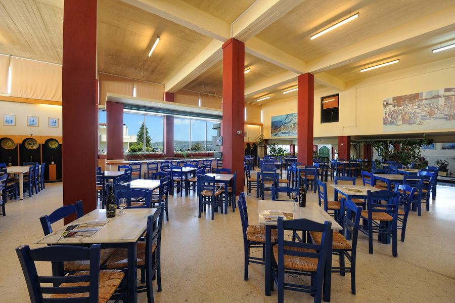 Minos - Miliarakis Winery tasting room with blue tables and chairs