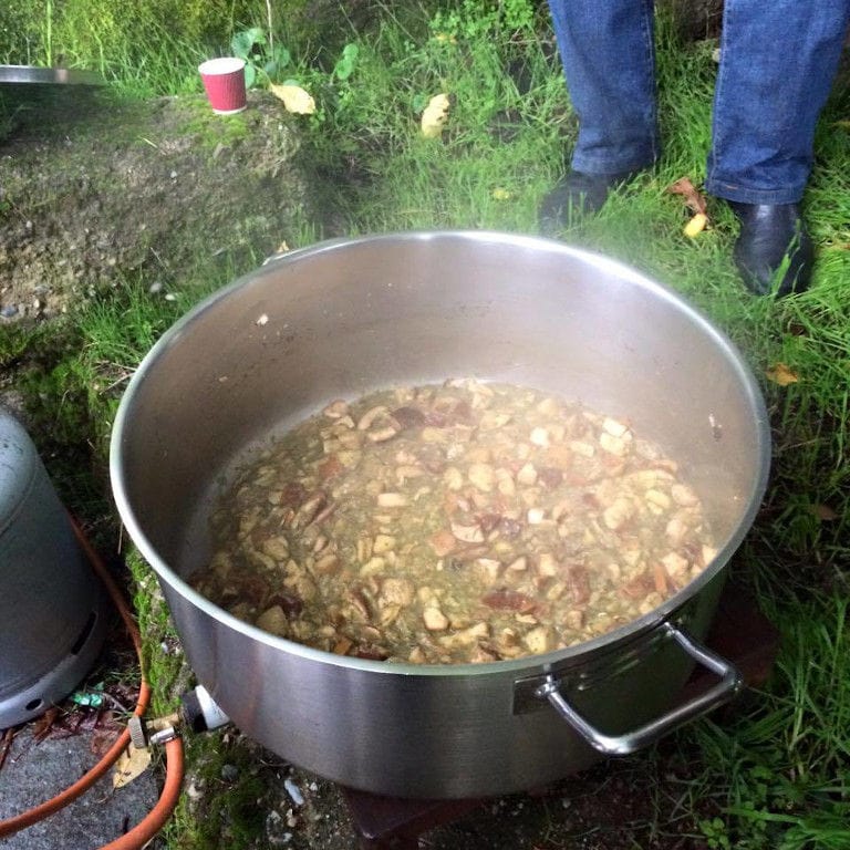 soupe with mushrooms boiling in a big saucepan on the gas bottle in the forest around Mushrooms Products of Grevena