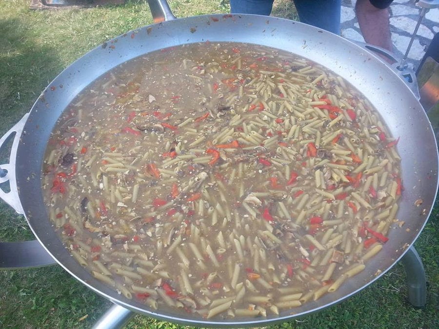 soupe with mushrooms boiling in a big saucepan on the gas bottle in the forest around Mushrooms Products of Grevena