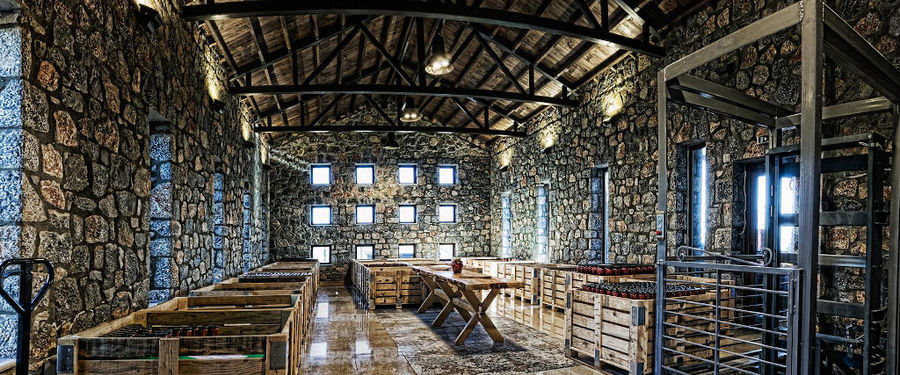 'Naoumidis All Peppers' cellar is a stone room with small windows and big wood crates