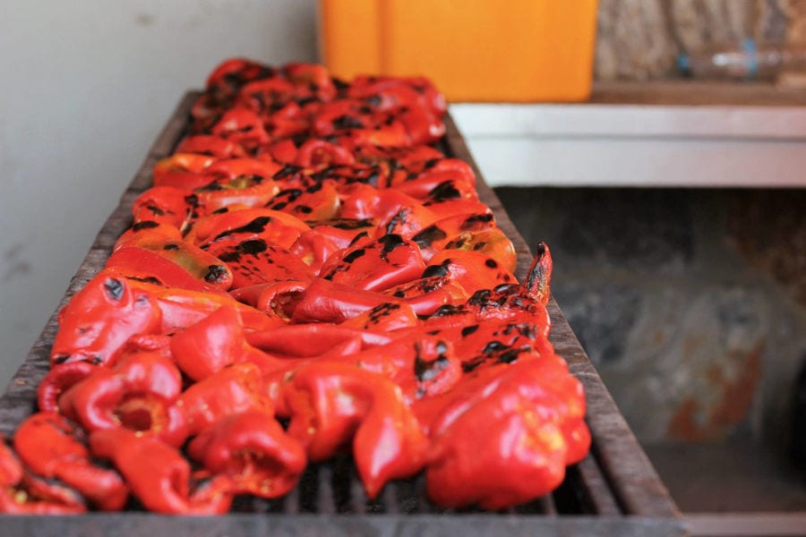 lying Florina red peppers on the grill to roast at 'Naoumidis All Peppers' plant