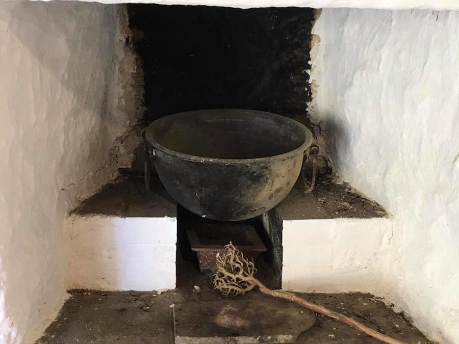 old cauldron in a niche in wall at 'Narlis Farm'