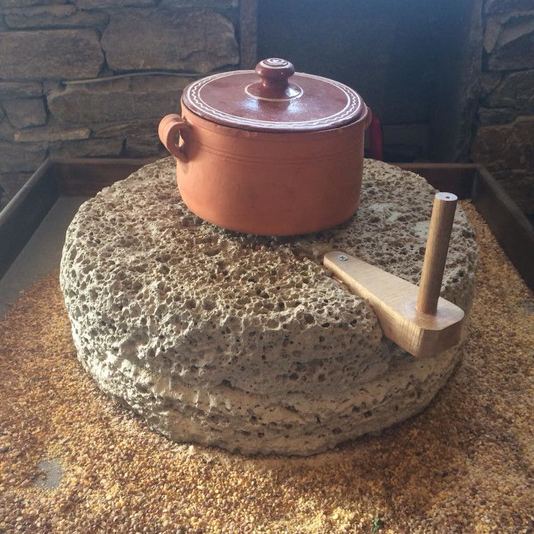 a ceramic pot with his cover at 'Narlis Farm' on old stone hand mill