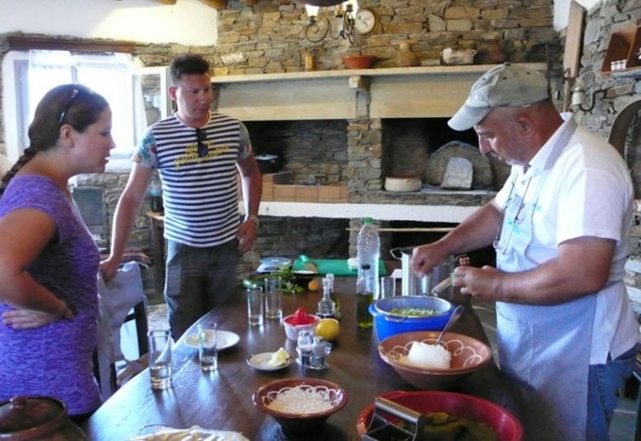 a couple watching a man cooking at 'Narlis Farm'a recipe with flour