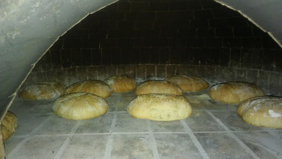 close-up of breads baking in stone oven at 'Narlis Farm'