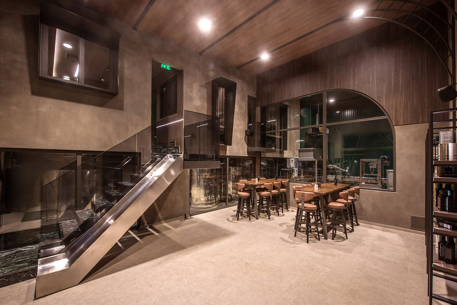 Savouidakis' Olive Oil Tasting Area, with 2 large tables and chairs.