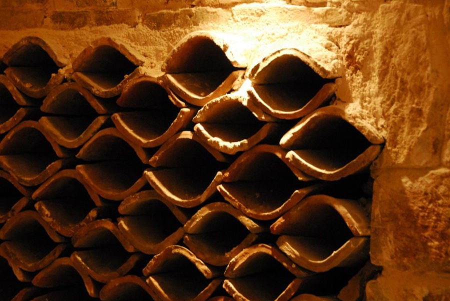 wine storage niches in a stone wall at Nikolou Winery cellar